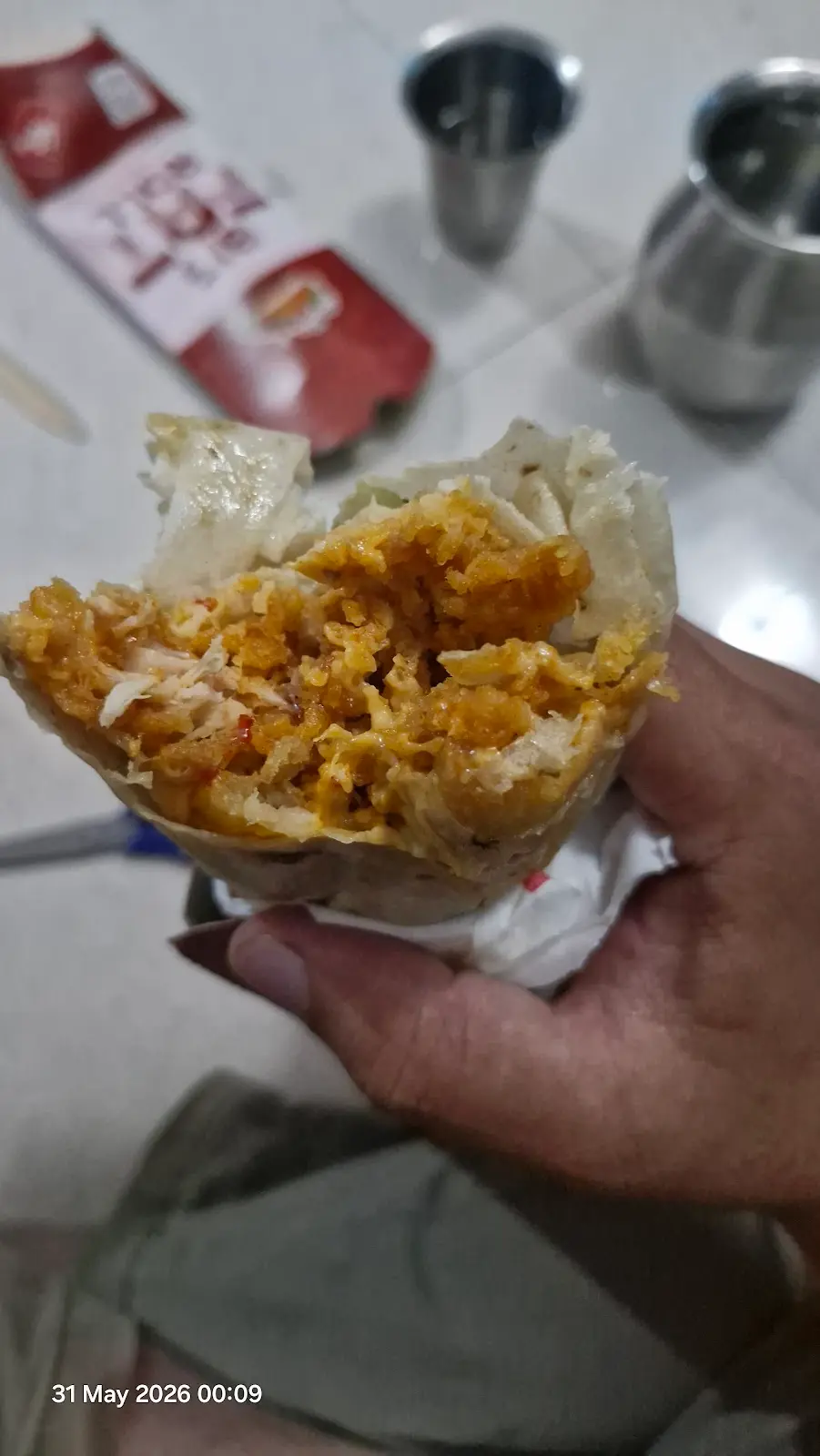 Hand Holding Chicken Roll