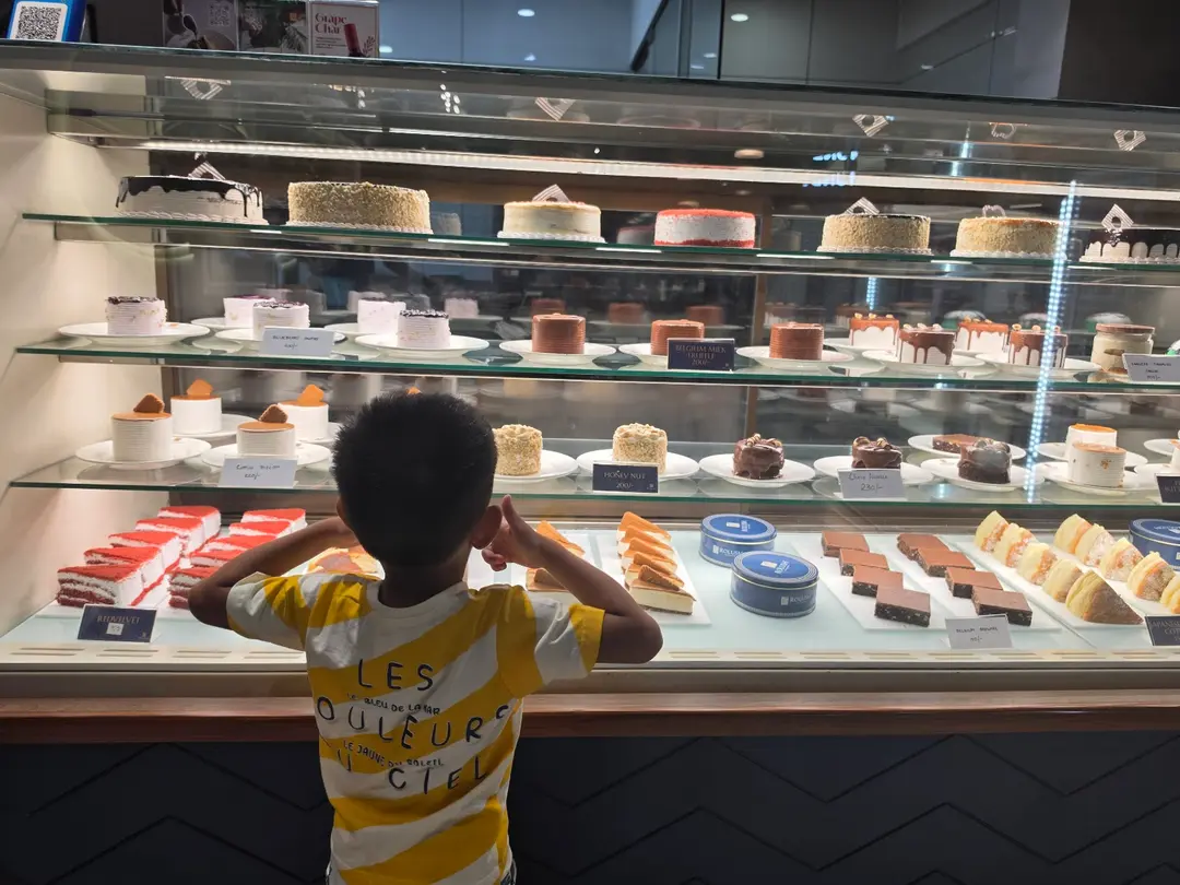 Child Admiring Pastries
